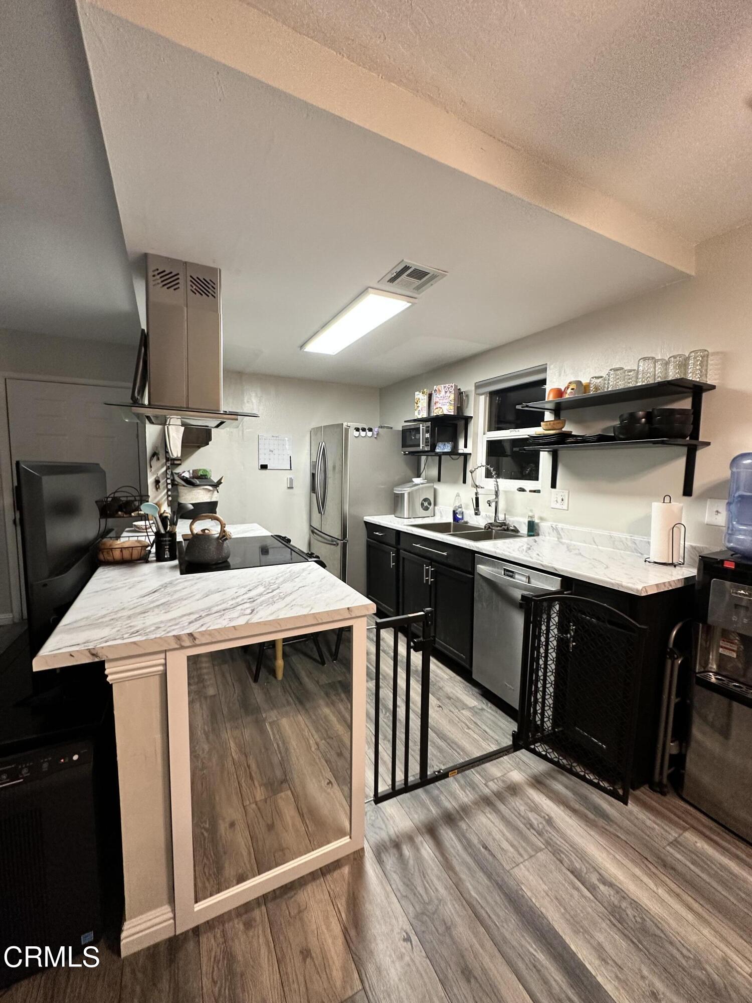 9926 Mission Vega Road, Unit 4 Santee, CA 92071 - Photo 8 of 22 a kitchen with kitchen island stainless steel appliances a sink and counter space