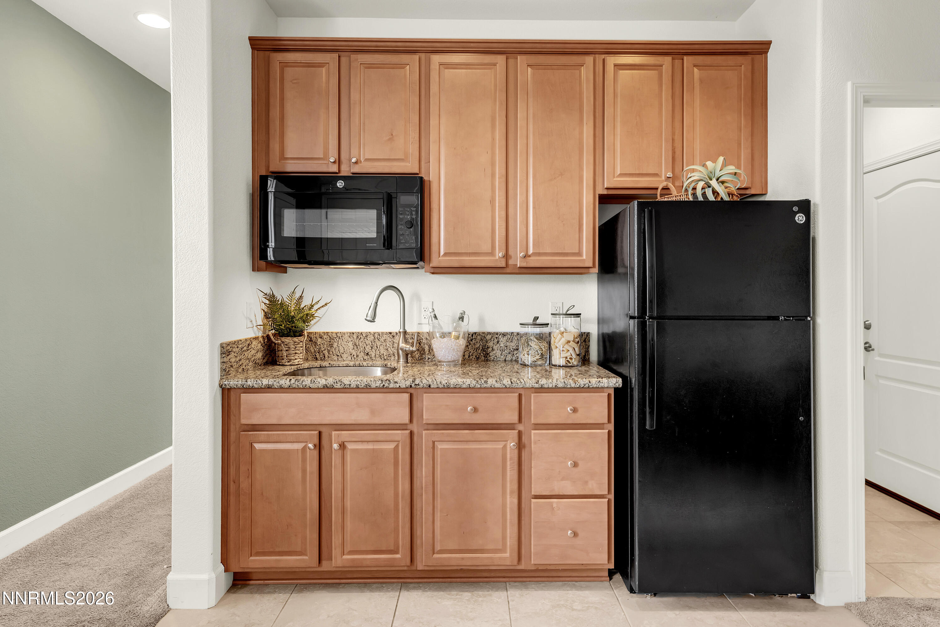 10150 Barrel Racer Drive Reno, NV 89521 - Photo 31 of 64 a kitchen with stainless steel appliances granite countertop a refrigerator and a sink