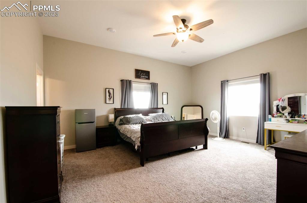 16750 Rabbit Track Trail Colorado Springs, CO 80930 - Photo 13 of 50 a bed room with a bed and a chandelier