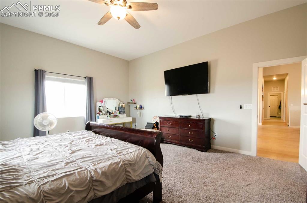 16750 Rabbit Track Trail Colorado Springs, CO 80930 - Photo 14 of 50 a bedroom with a bed and a flat screen tv