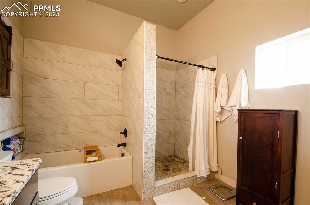 16750 Rabbit Track Trail Colorado Springs, CO 80930 - Photo 17 of 50 a bathroom with a shower toilet and sink