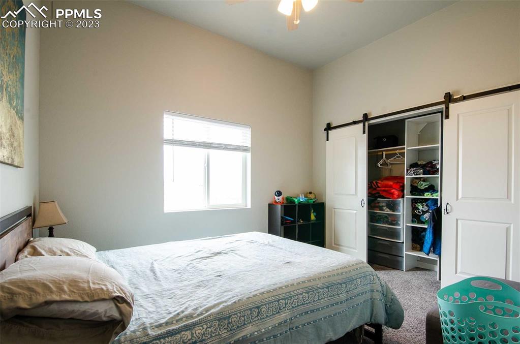 16750 Rabbit Track Trail Colorado Springs, CO 80930 - Photo 18 of 50 a bedroom with a bed and a window