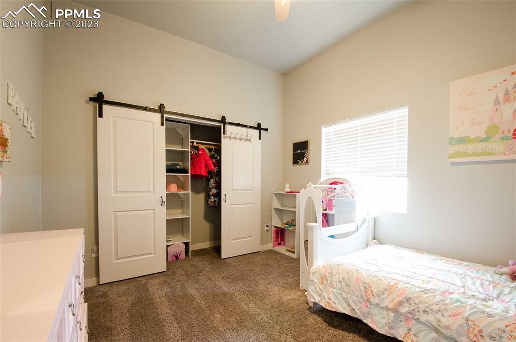 16750 Rabbit Track Trail Colorado Springs, CO 80930 - Photo 22 of 50 a bedroom with a bed and a window