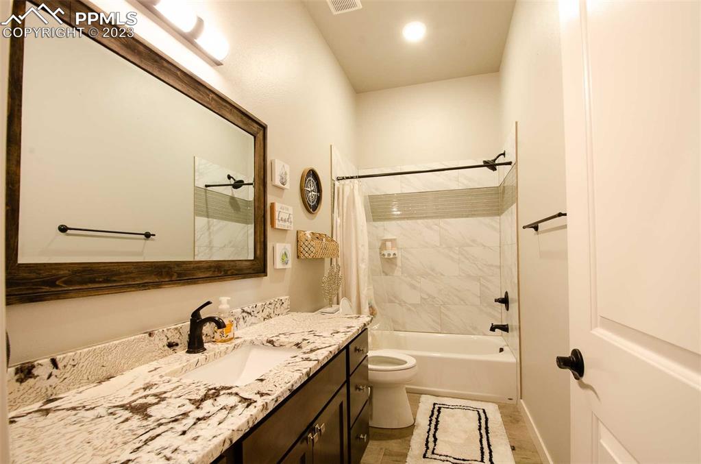 16750 Rabbit Track Trail Colorado Springs, CO 80930 - Photo 25 of 50 a bathroom with a granite countertop sink mirror and a bath tub