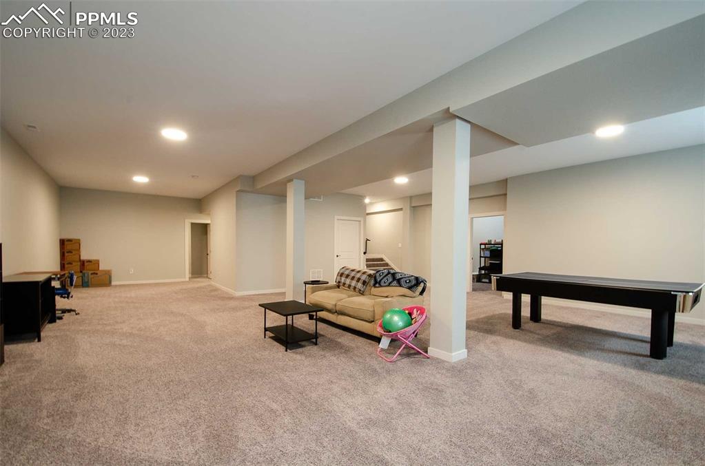 16750 Rabbit Track Trail Colorado Springs, CO 80930 - Photo 28 of 50 a living room with furniture and a table