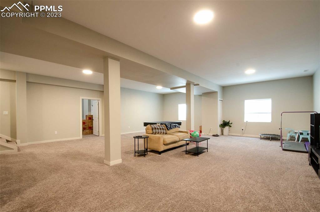 16750 Rabbit Track Trail Colorado Springs, CO 80930 - Photo 29 of 50 a bed room with furniture and a lamp