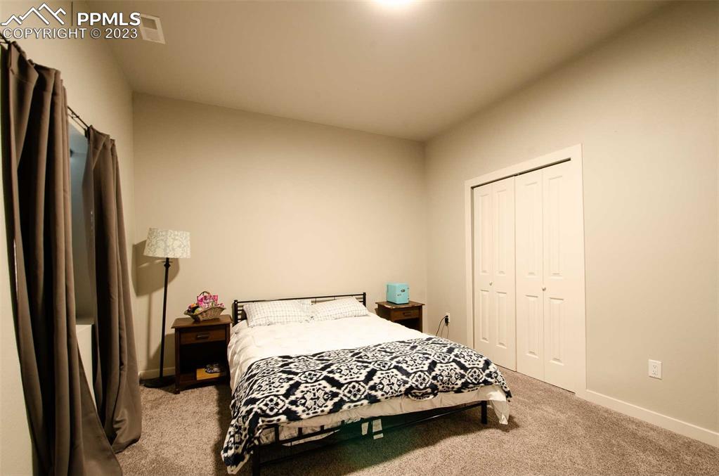 16750 Rabbit Track Trail Colorado Springs, CO 80930 - Photo 32 of 50 a bedroom with a bed and a refrigerator