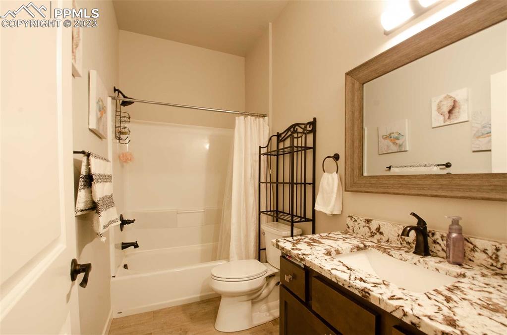 16750 Rabbit Track Trail Colorado Springs, CO 80930 - Photo 37 of 50 a bathroom with a granite countertop sink toilet and shower