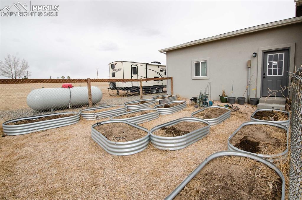 16750 Rabbit Track Trail Colorado Springs, CO 80930 - Photo 43 of 50 a kitchen with stainless steel appliances granite countertop a sink and a stove