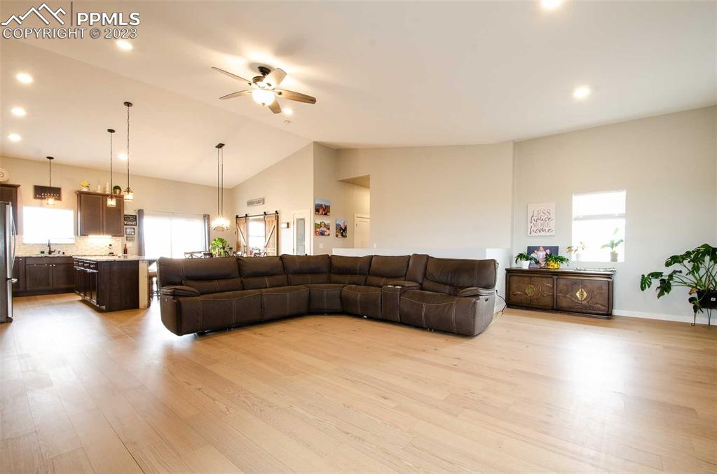 16750 Rabbit Track Trail Colorado Springs, CO 80930 - Photo 5 of 50 a living room with furniture and a chandelier