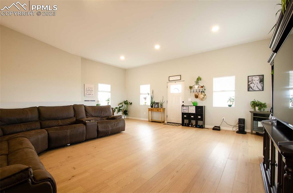16750 Rabbit Track Trail Colorado Springs, CO 80930 - Photo 6 of 50 a living room with furniture and a wooden floor