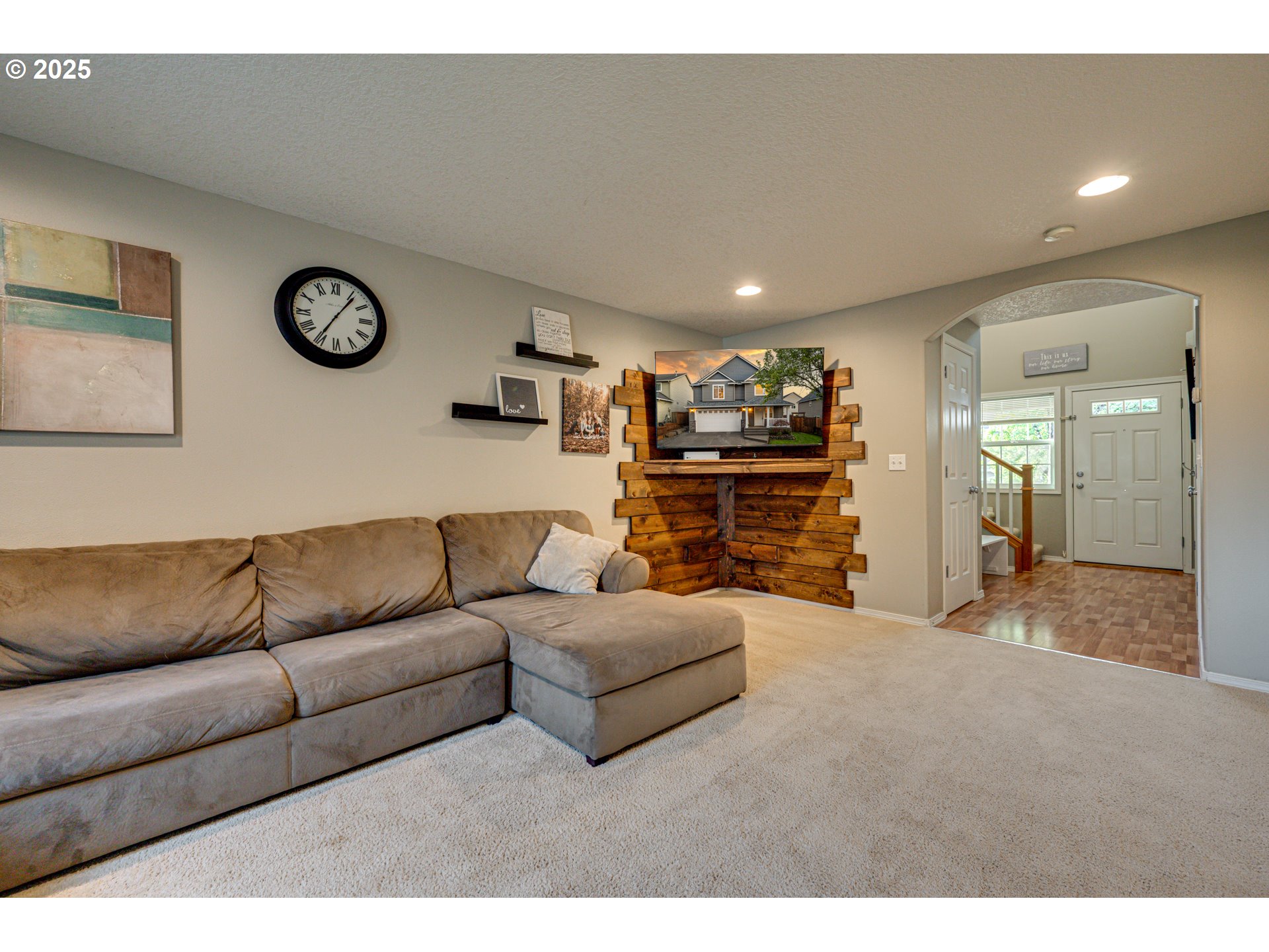 1825 North 9th Way Ridgefield, WA 98642 - Photo 11 of 30 a living room with furniture a clock on wall and a table