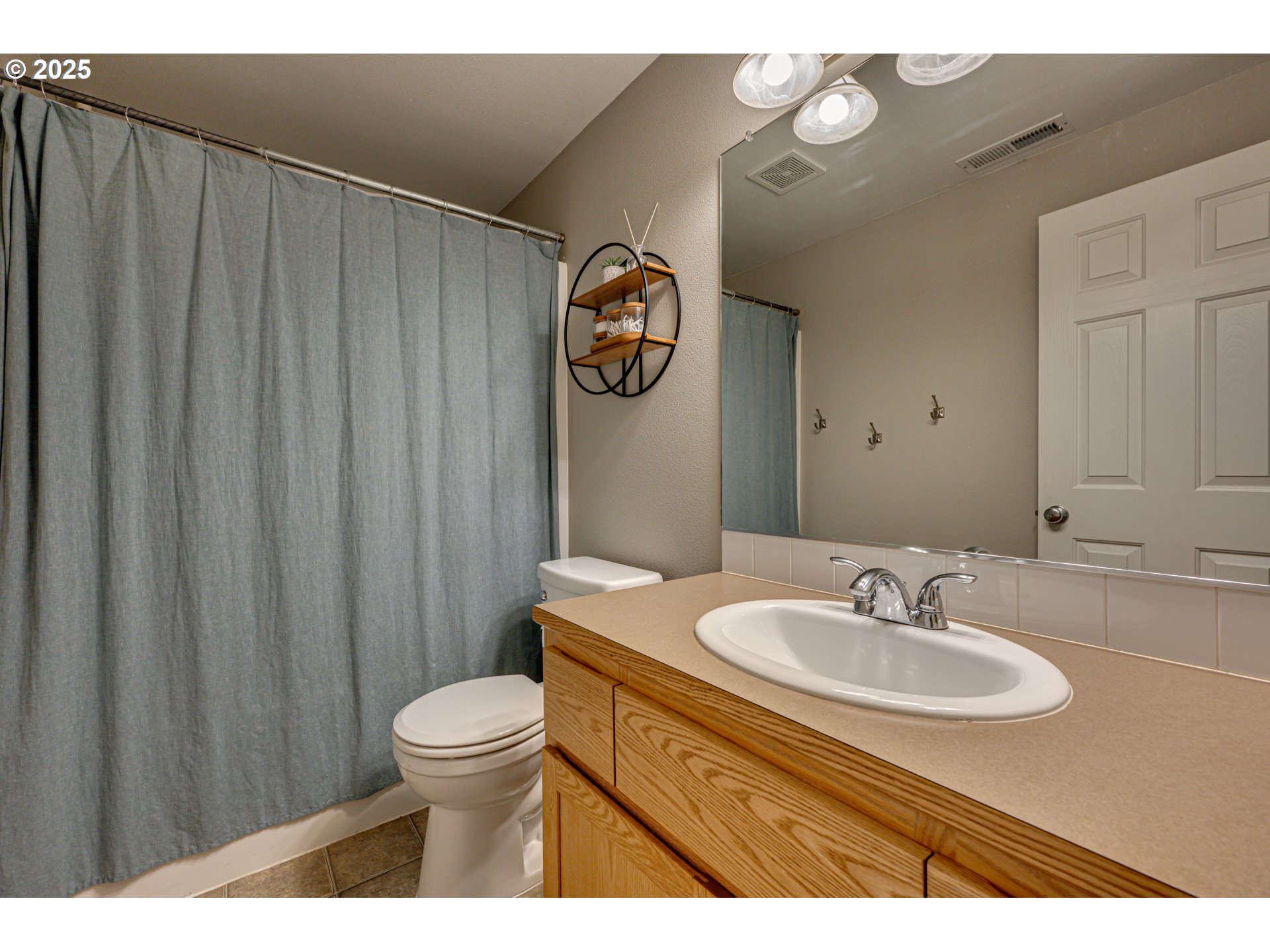1825 North 9th Way Ridgefield, WA 98642 - Photo 17 of 30 a bathroom with a sink a toilet and a mirror