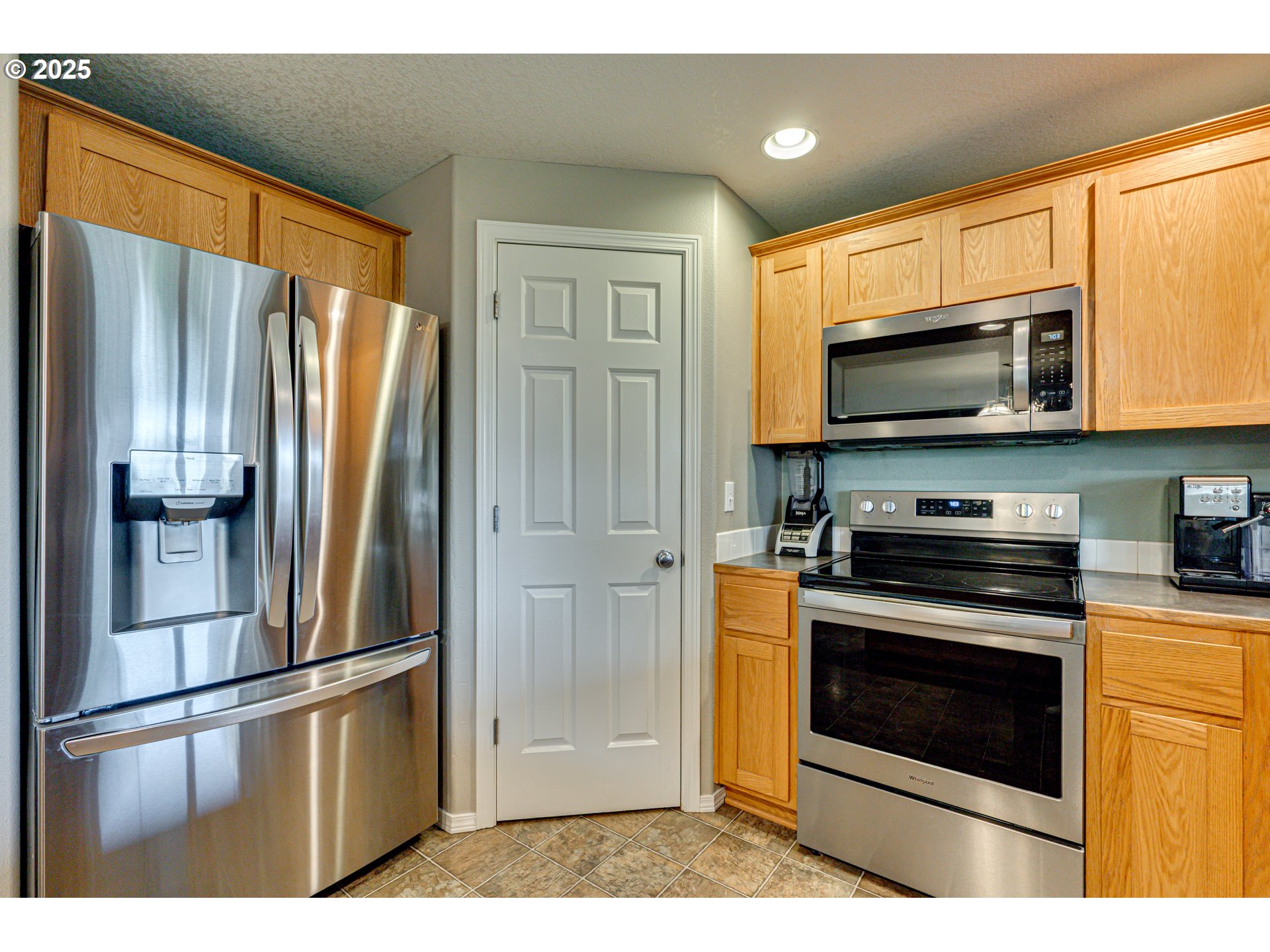 1825 North 9th Way Ridgefield, WA 98642 - Photo 6 of 30 a kitchen with stainless steel appliances granite countertop a refrigerator stove and microwave
