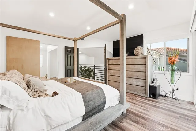 a bedroom with a large bed and a window