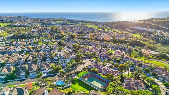 an aerial view of residential building with trees in the background