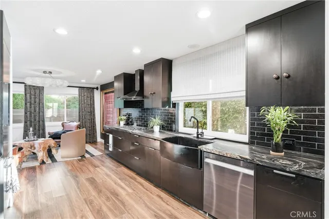 a large kitchen with kitchen island a large window in it