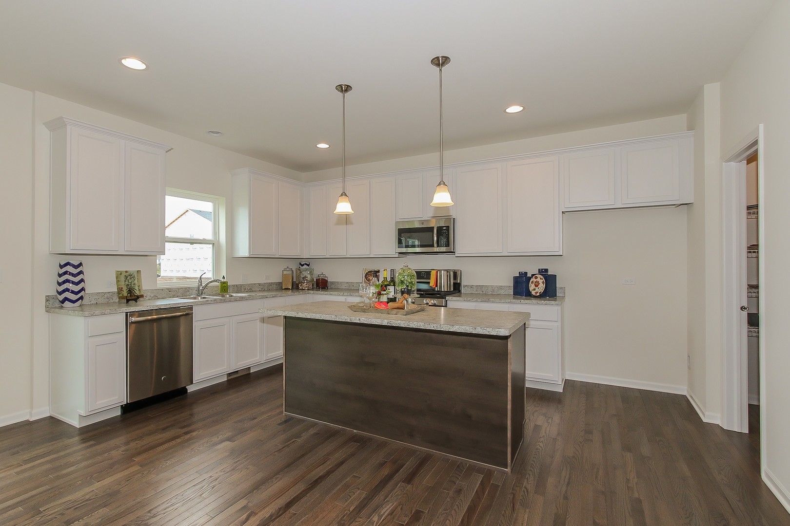 440 Radcliff Lane South Elgin, IL 60177 - Photo 9 of 31 a kitchen with sink cabinets and wooden floor