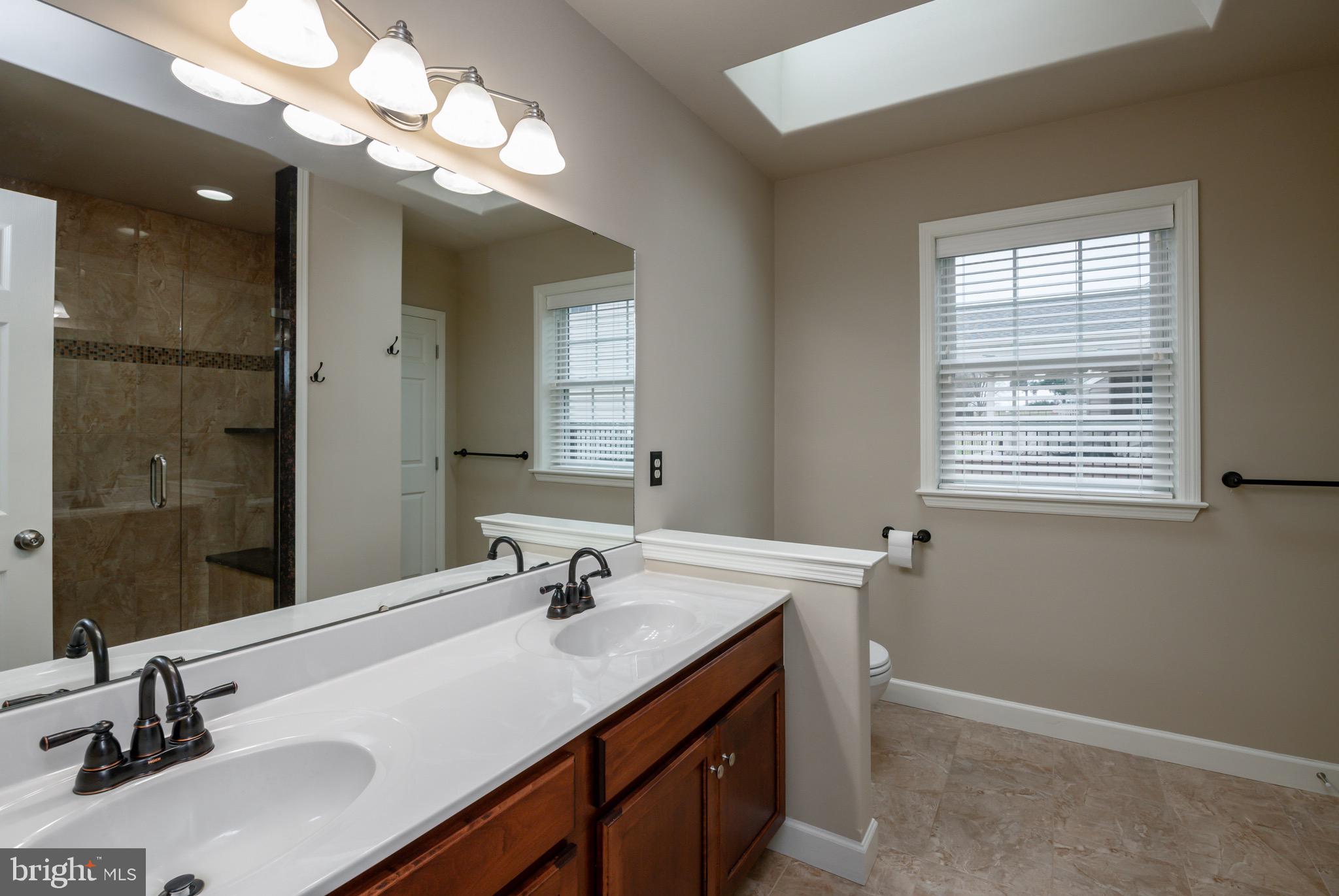 654 Ebersole Road Reading, PA 19605 - Photo 15 of 27 a bathroom with a sink double vanity and a mirror
