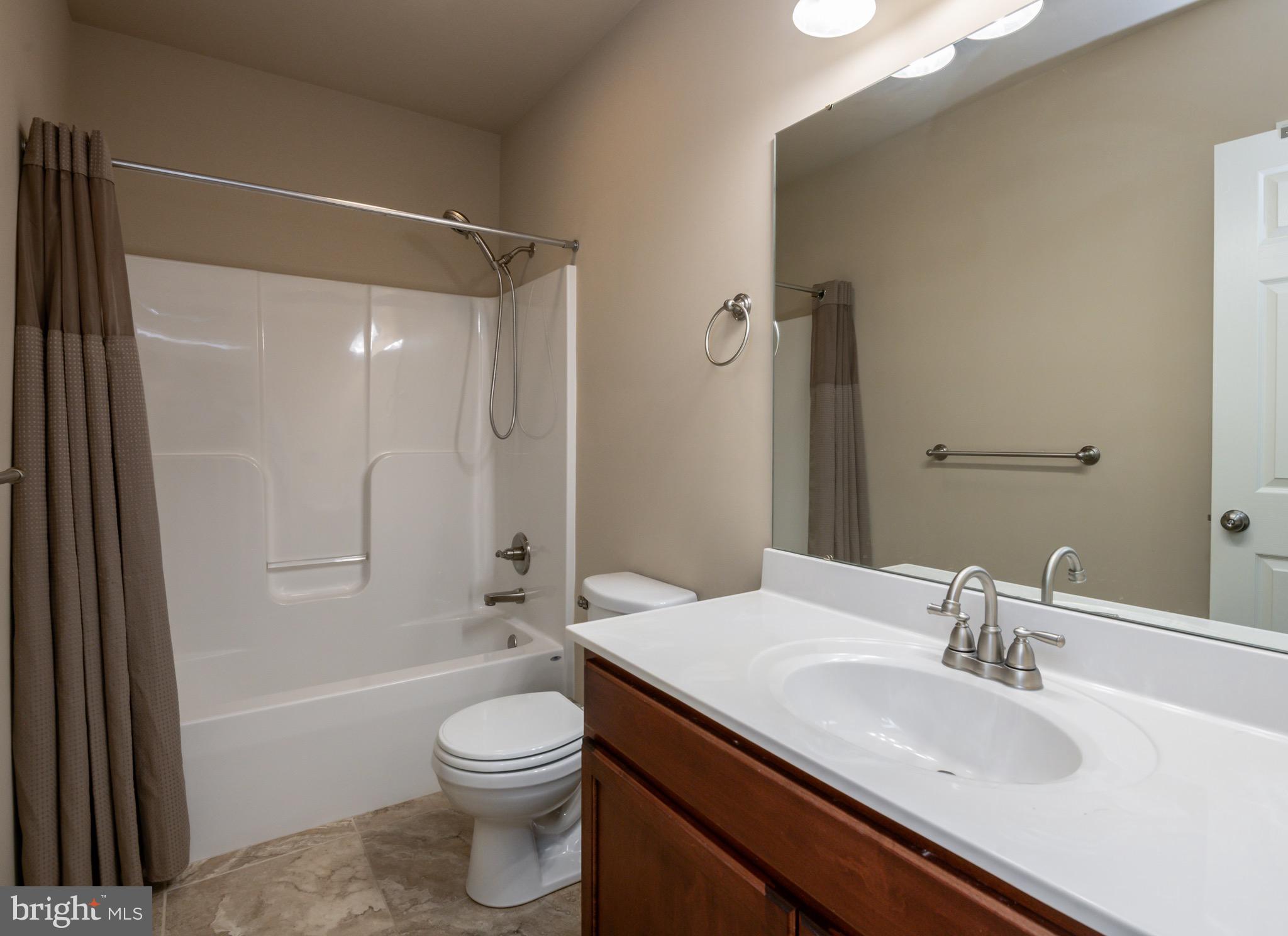 654 Ebersole Road Reading, PA 19605 - Photo 18 of 27 a bathroom with a sink a toilet and shower