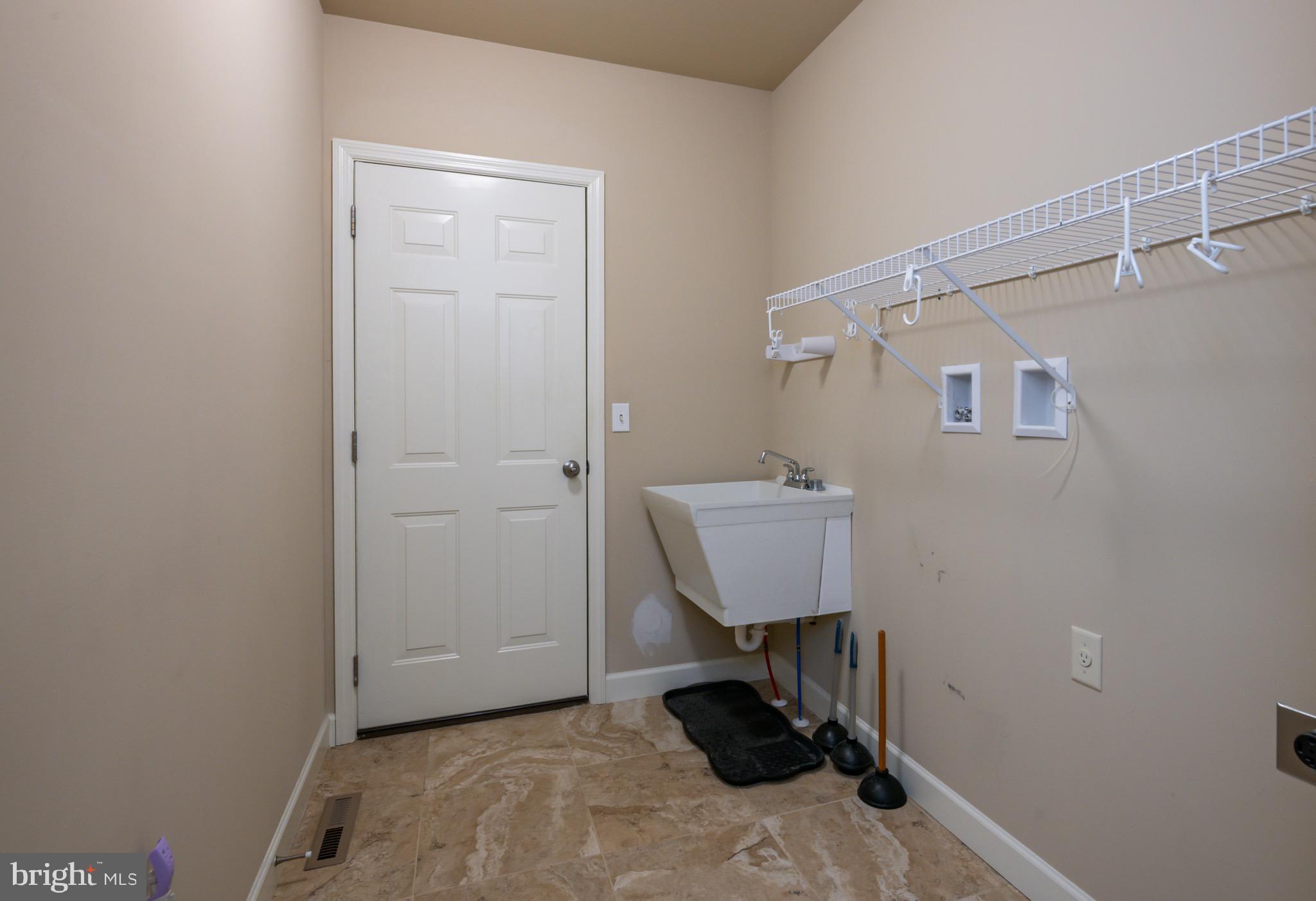 654 Ebersole Road Reading, PA 19605 - Photo 19 of 27 a view of a room with a wooden floor and a sink