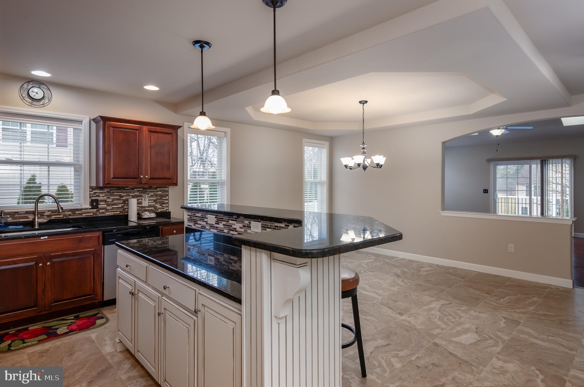 654 Ebersole Road Reading, PA 19605 - Photo 6 of 27 a kitchen with kitchen island a sink and chandelier