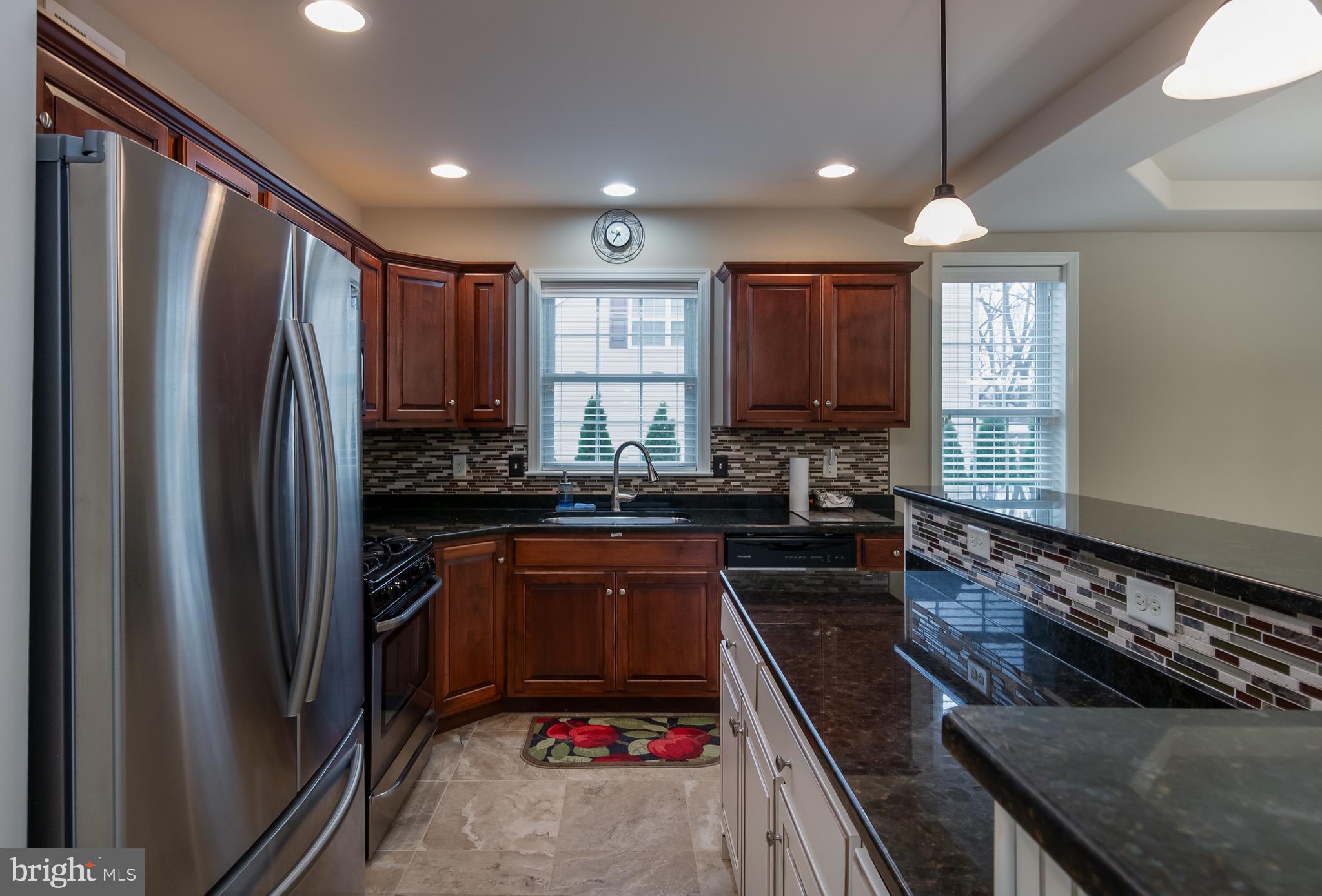 654 Ebersole Road Reading, PA 19605 - Photo 7 of 27 a kitchen with kitchen island granite countertop a refrigerator stove and sink