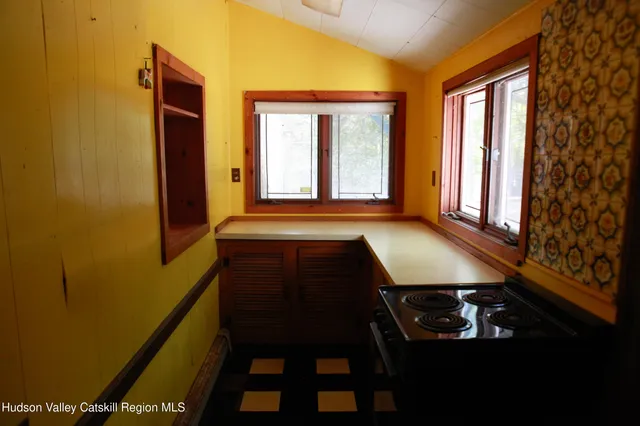 a room with granite countertop a stove and a sink