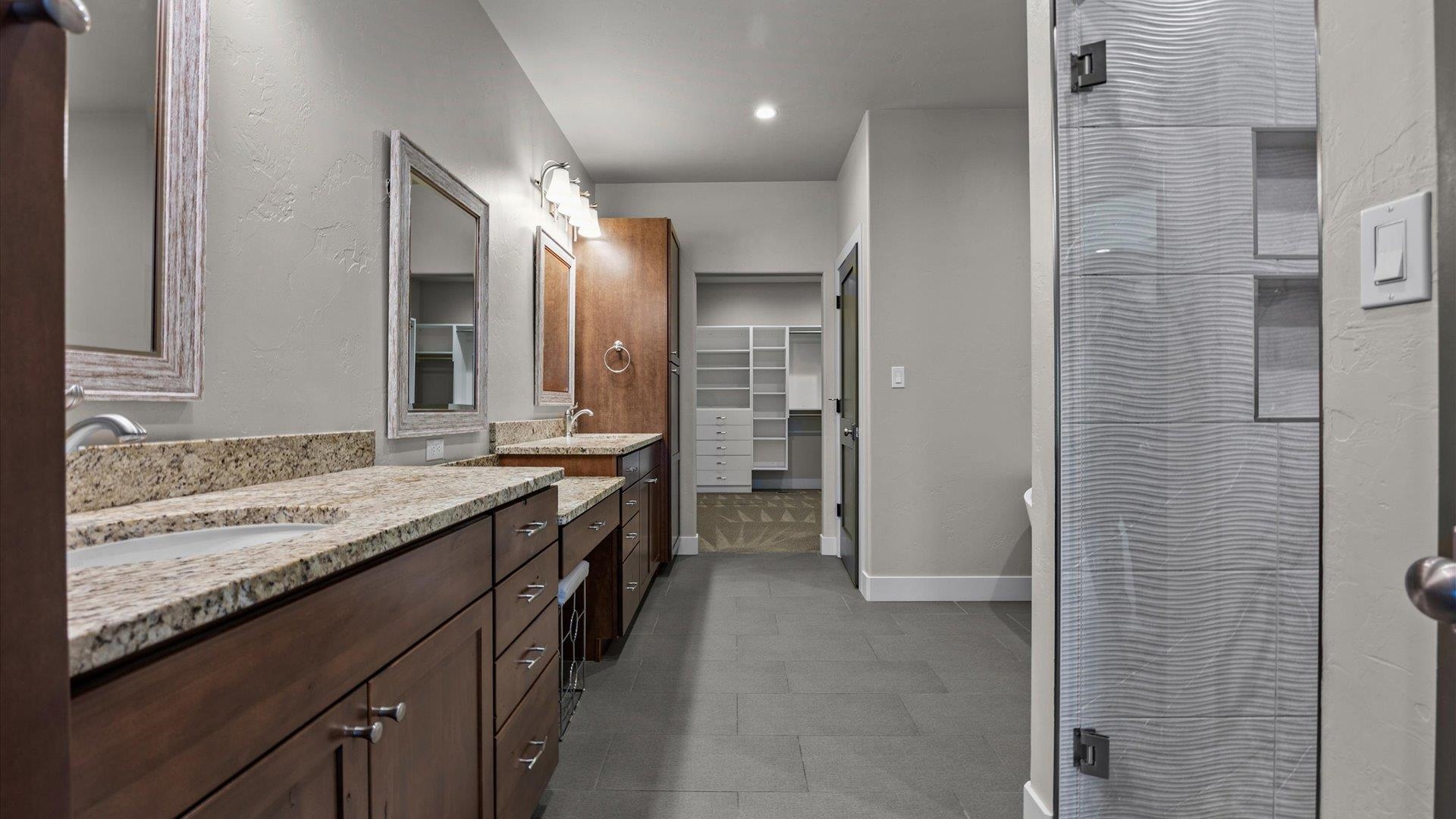 2041 J J 1/2 Road Fruita, CO 81521 - Photo 16 of 42 a bathroom with a granite countertop sink mirror and a shower