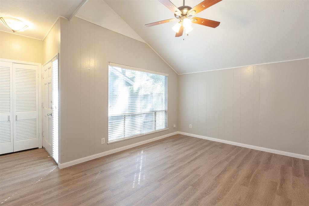 3407 Grooms Street Austin, TX 78705 - Photo 5 of 10 an empty room with wooden floor fan and windows