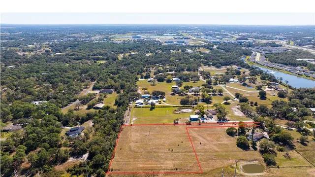 an aerial view of residential houses with city view