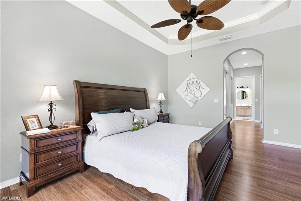 349 Harvard Lane Naples, FL 34104 - Photo 12 of 31 a bedroom with bed and wooden floor