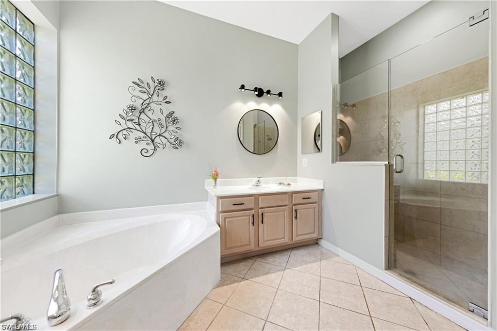 349 Harvard Lane Naples, FL 34104 - Photo 14 of 31 a spacious bathroom with a tub sink and mirror