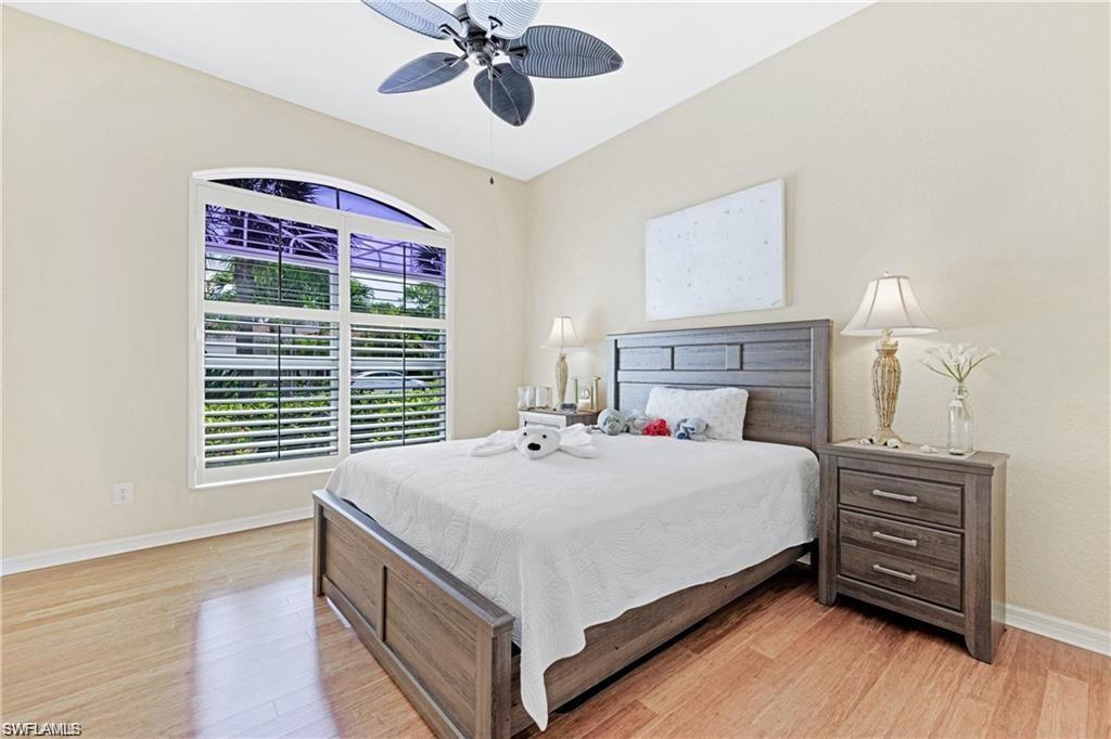 349 Harvard Lane Naples, FL 34104 - Photo 15 of 31 a bed room with a bed and a chandelier