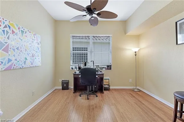 a workspace with furniture window and wooden floor