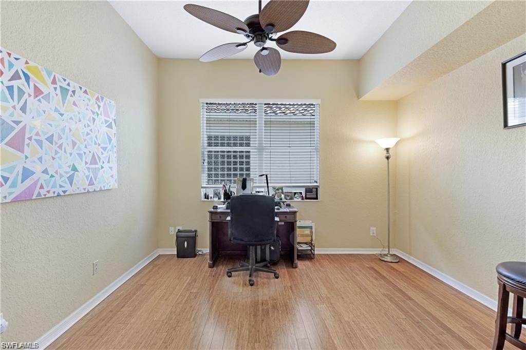 349 Harvard Lane Naples, FL 34104 - Photo 17 of 31 a workspace with furniture window and wooden floor