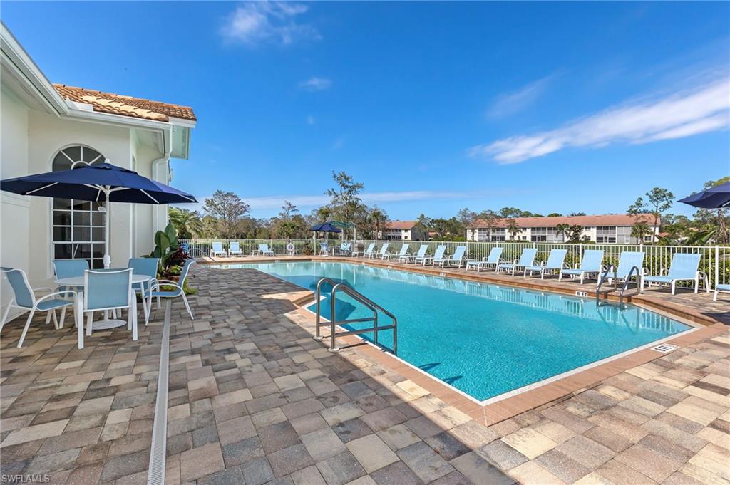 349 Harvard Lane Naples, FL 34104 - Photo 23 of 31 a view of a swimming pool with a patio