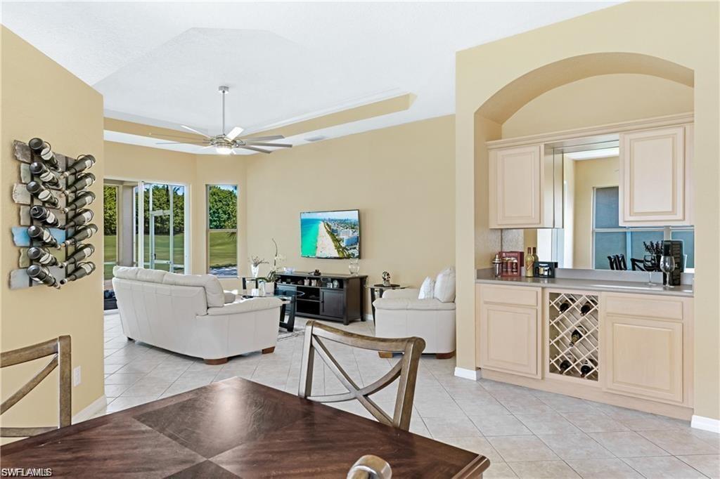 349 Harvard Lane Naples, FL 34104 - Photo 4 of 31 a living room with furniture and a chandelier