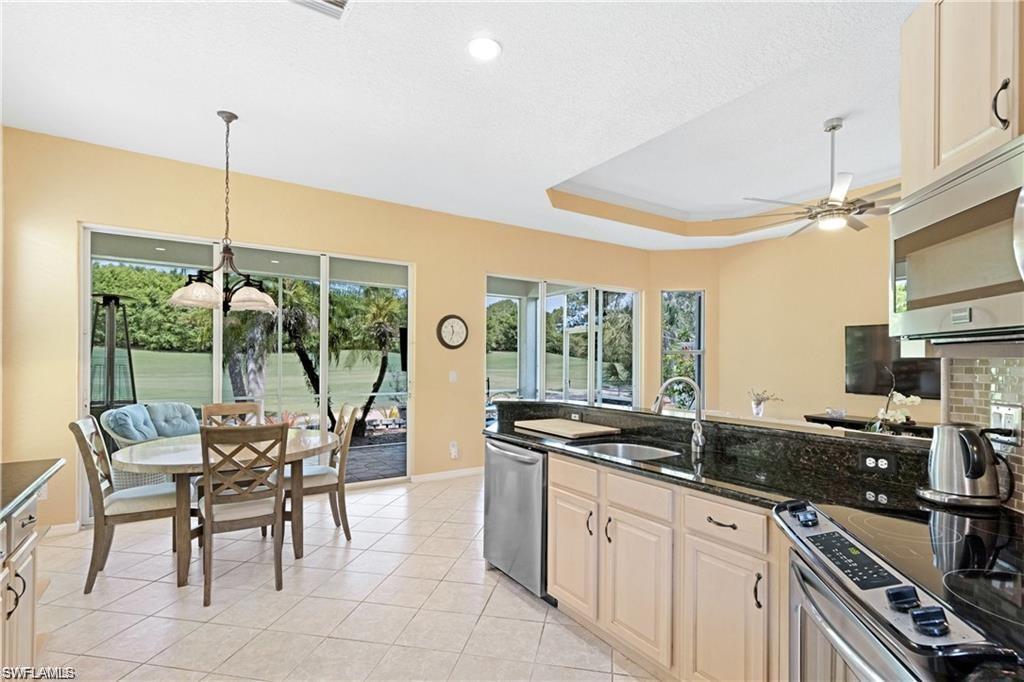 349 Harvard Lane Naples, FL 34104 - Photo 8 of 31 a kitchen with counter top space cabinets and outdoor view