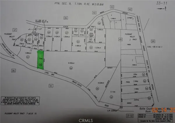 a view of a green field with a tree