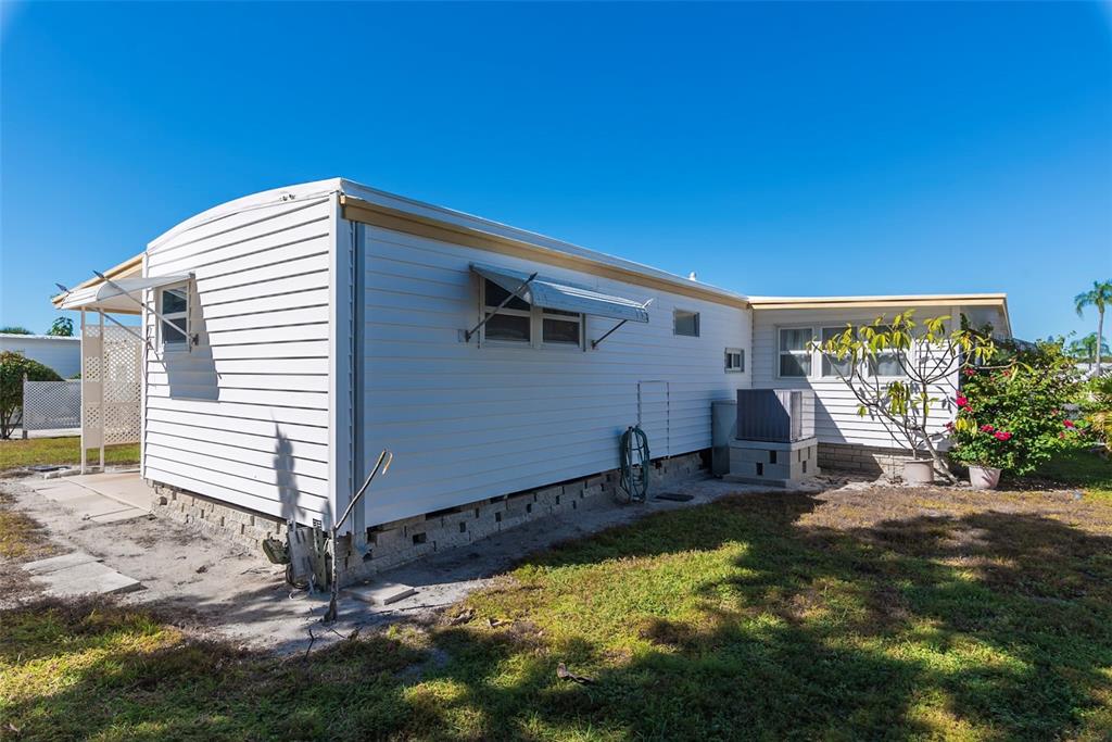 3301 Alt 19, Unit 404 Dunedin, FL 34698 - Photo 18 of 67 a backyard of a house with yard and outdoor seating