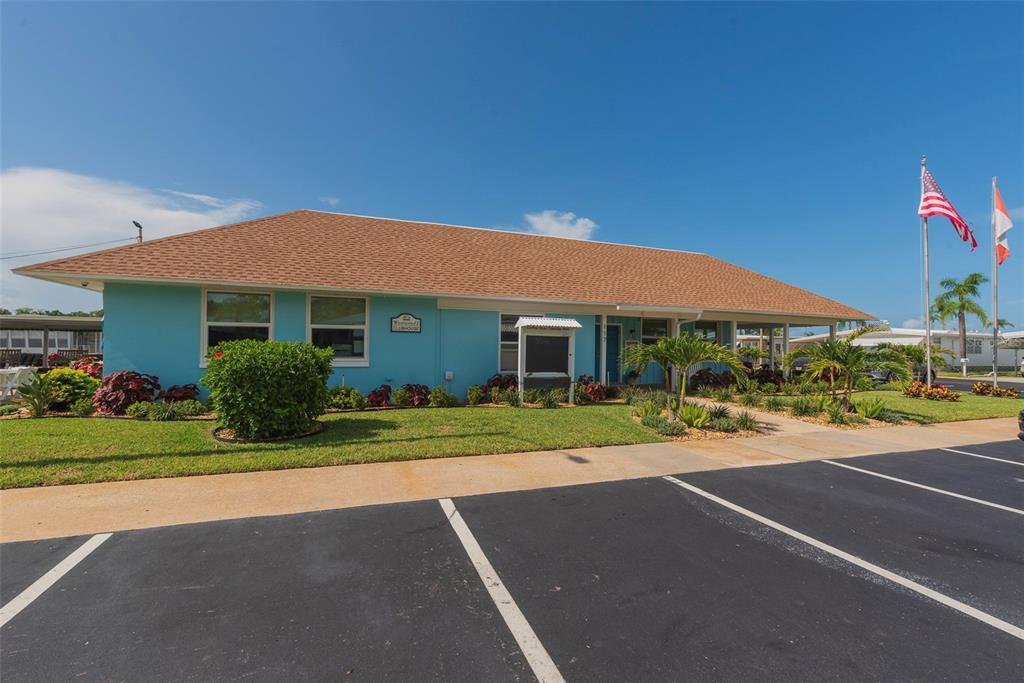 3301 Alt 19, Unit 404 Dunedin, FL 34698 - Photo 20 of 67 a front view of a house with a yard and garage