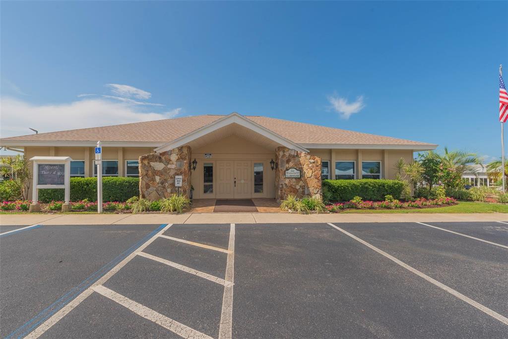 3301 Alt 19, Unit 404 Dunedin, FL 34698 - Photo 21 of 67 a front view of a house with a yard and potted plants