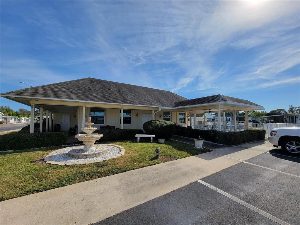 3301 Alt 19, Unit 404 Dunedin, FL 34698 - Photo 23 of 67 a front view of a house with garden and porch