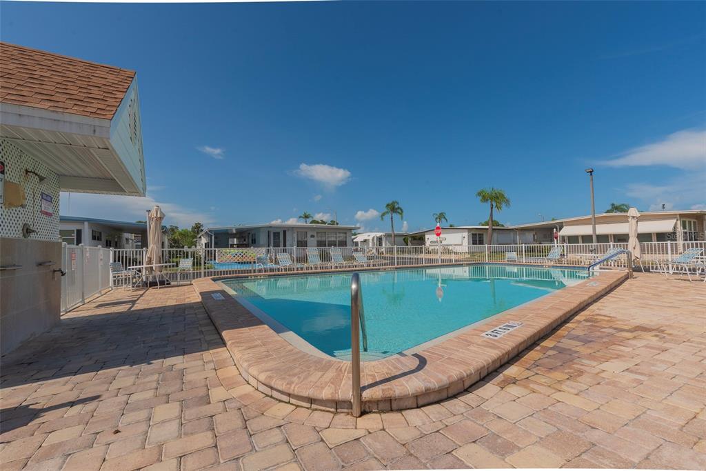 3301 Alt 19, Unit 404 Dunedin, FL 34698 - Photo 28 of 67 a view of a swimming pool with a lounge chair