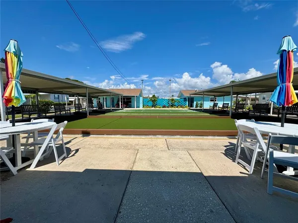 a view of a patio with a table and chairs under an umbrella