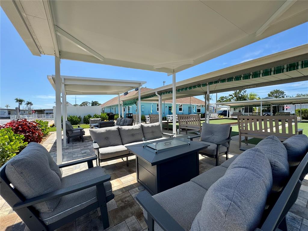 3301 Alt 19, Unit 404 Dunedin, FL 34698 - Photo 45 of 67 a living room with patio furniture and a potted plant