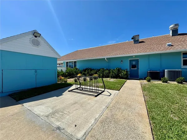 a view of a house with backyard porch and sitting area