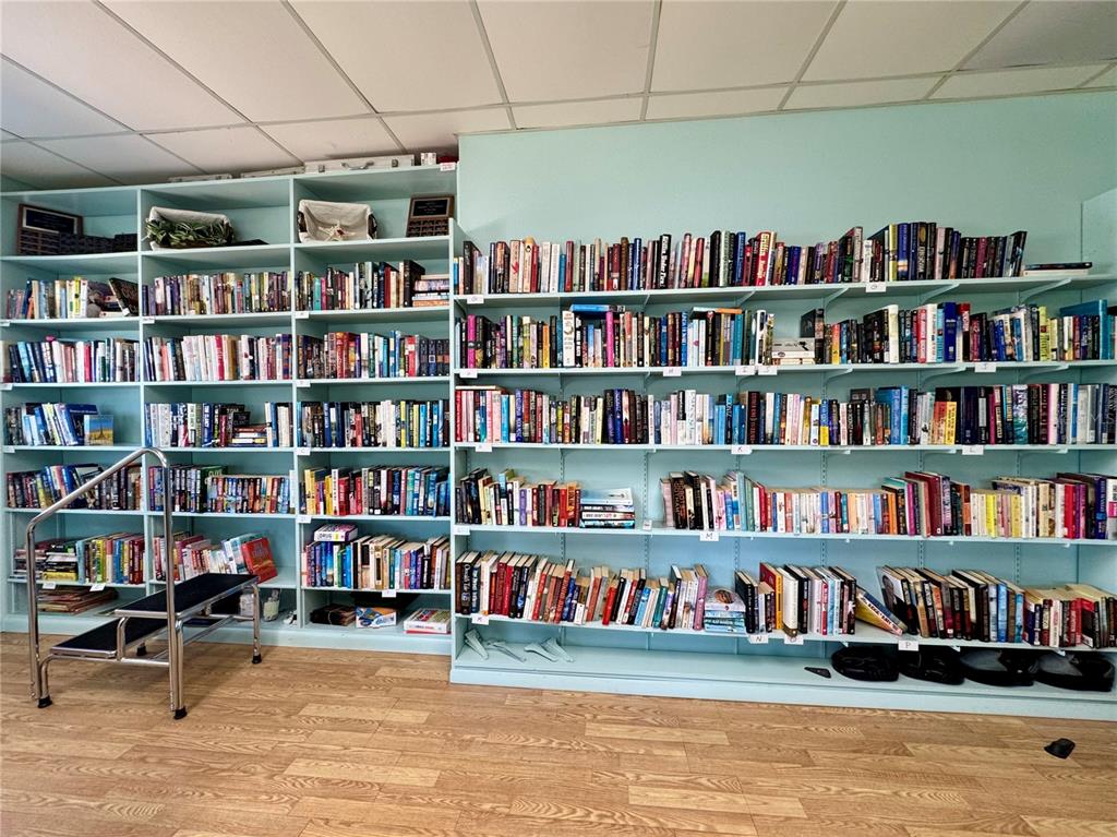 3301 Alt 19, Unit 404 Dunedin, FL 34698 - Photo 56 of 67 a view of a book shelf with books on the floor
