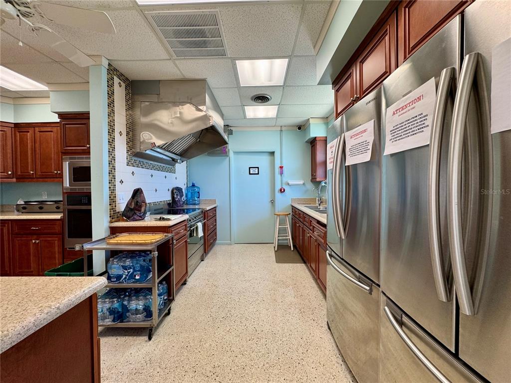 3301 Alt 19, Unit 404 Dunedin, FL 34698 - Photo 58 of 67 a kitchen with stainless steel appliances granite countertop a refrigerator a stove and a sink